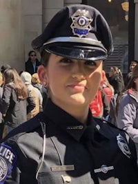 a woman in a police uniform posing for a photo