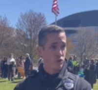 a police officer talking to a crowd of people
